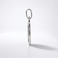 A silver elongated oval keychain with engraved text hangs from an oval metal ring against a white background.