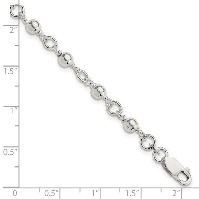 Silver-tone bracelet with alternating round ball beads and open circular link elements, displayed against a ruler showing approximately two inches in length.