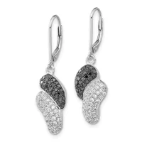 A pair of silver lever-back earrings with curved pendants paved with black and white diamonds in a swirled pattern.
