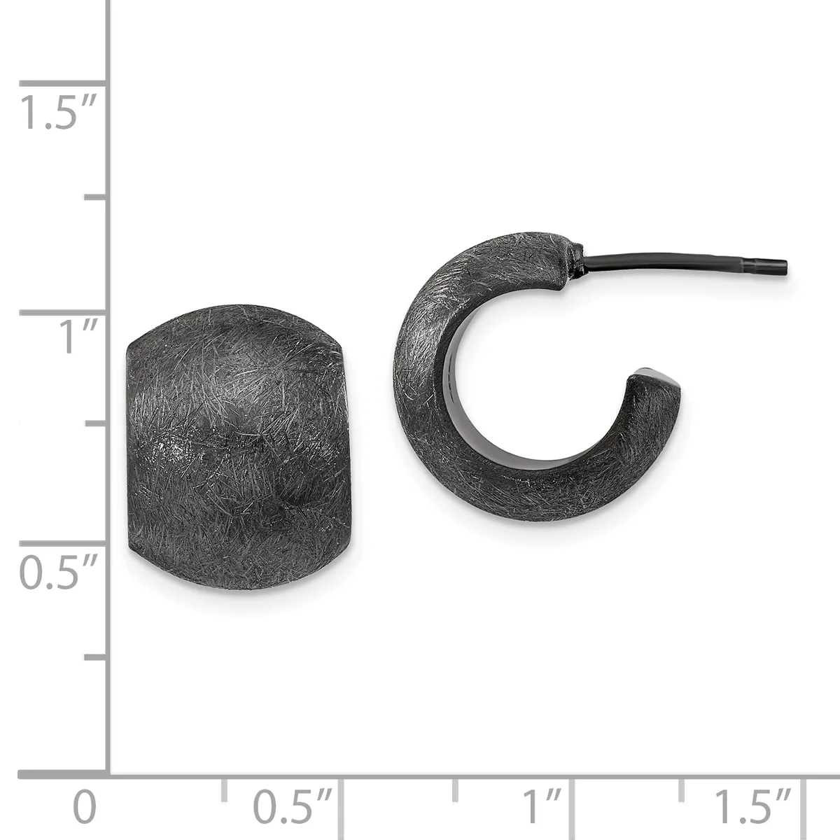 Two dark textured metal earrings displayed next to a ruler showing approximately one inch in height: a cylindrical stud on the left and a curved hoop with a post on the right.