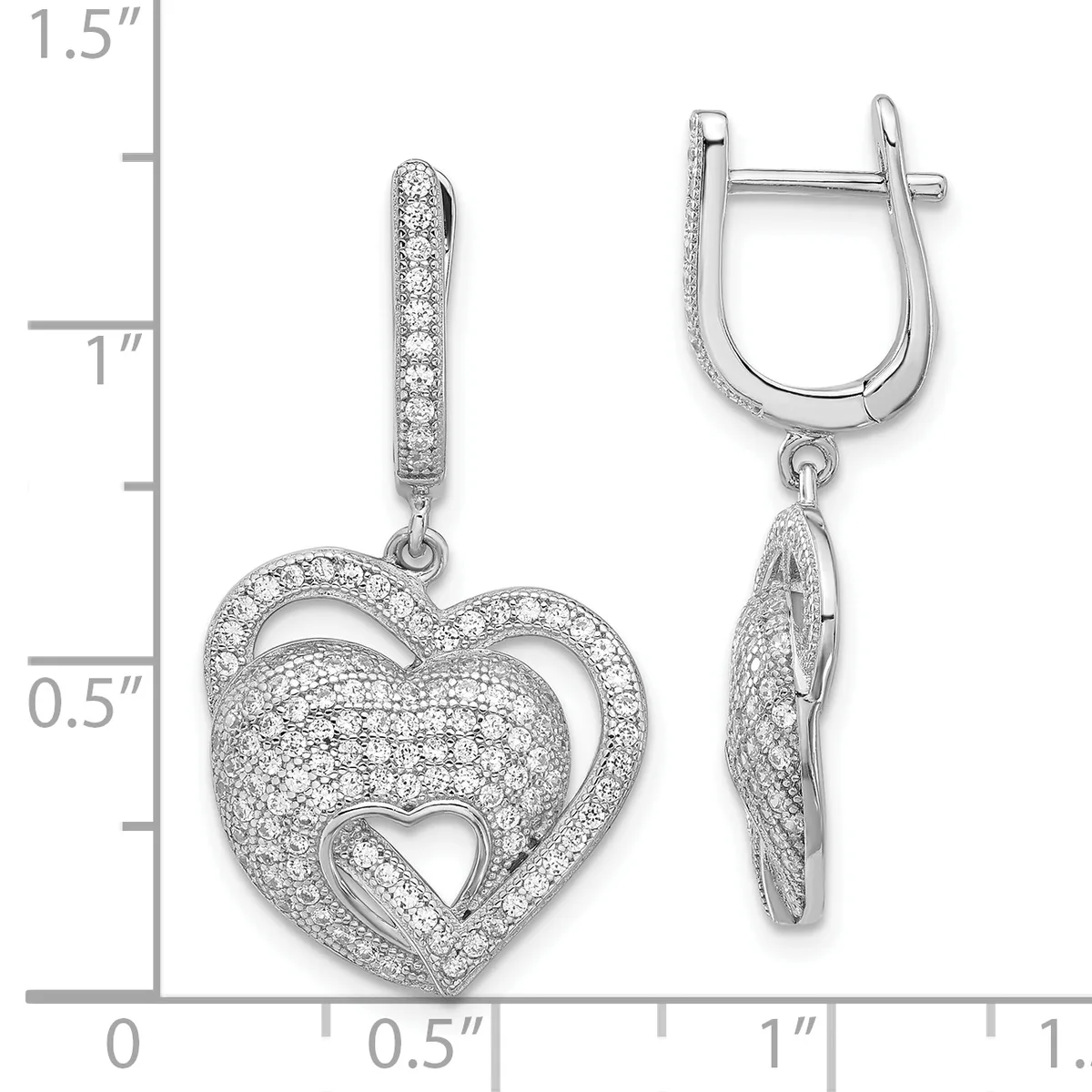 Pair of silver heart-shaped drop earrings with diamond pave settings and smaller heart cutouts in the center, displayed against a measurement scale.