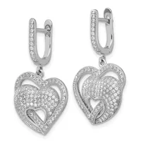 A pair of silver heart-shaped drop earrings with diamond pavé setting, featuring nested hearts with a small cutout heart at the center, suspended from hinged rectangular upper posts also set with diamonds.