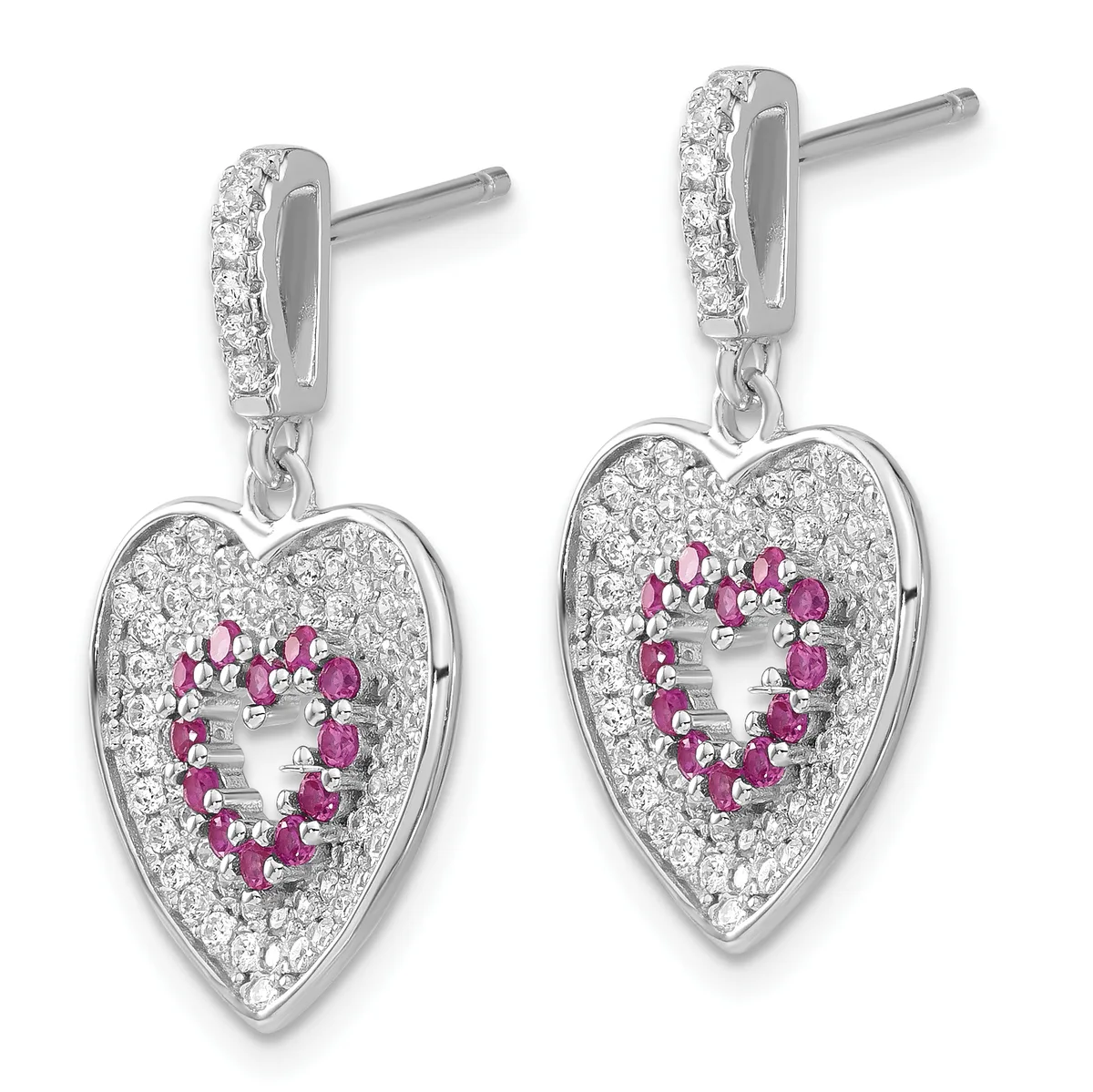 Pair of silver heart-shaped dangle earrings with diamond-paved tops, ruby gemstones arranged in a heart outline within each heart pendant, and post backs.