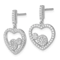 Pair of silver heart-shaped drop earrings with diamond pave settings and smaller heart charms suspended inside the larger hearts.
