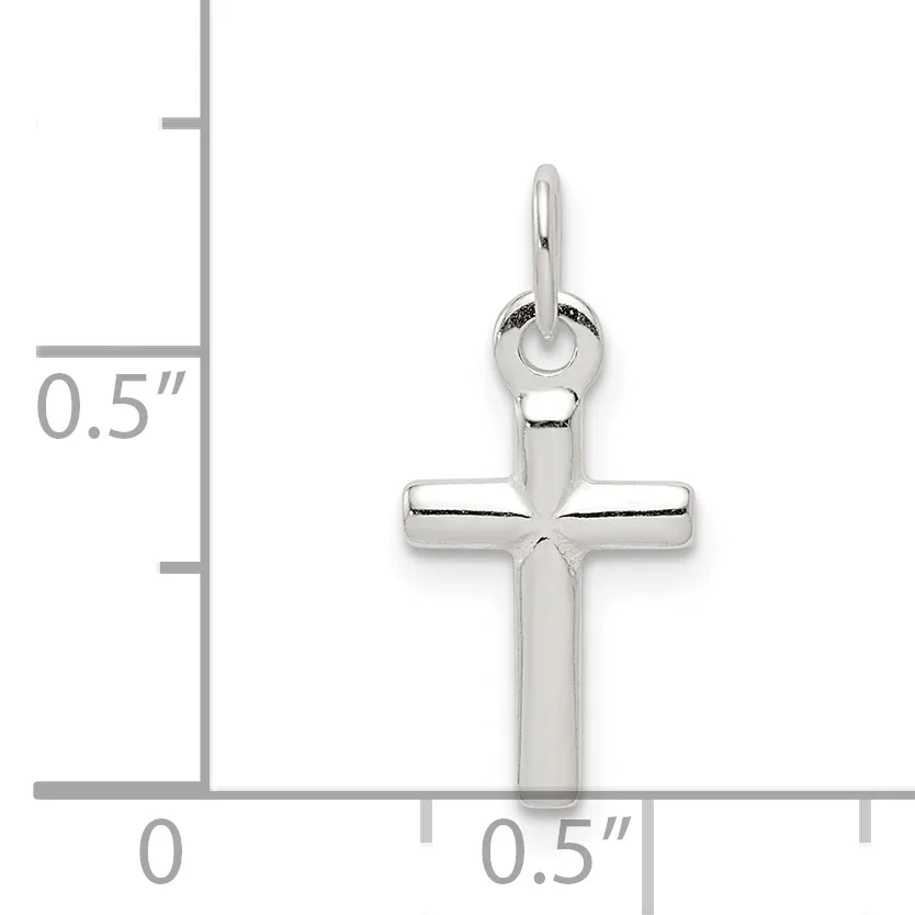 A polished silver cross pendant with rounded edges shown next to a ruler indicating its size is approximately half an inch wide and tall.