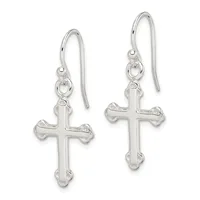 A pair of silver cross earrings with decorative edges hanging from curved ear wires.