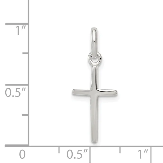 A silver cross pendant shown next to a ruler indicating its size is approximately 0.75 inches wide and 1 inch tall.
