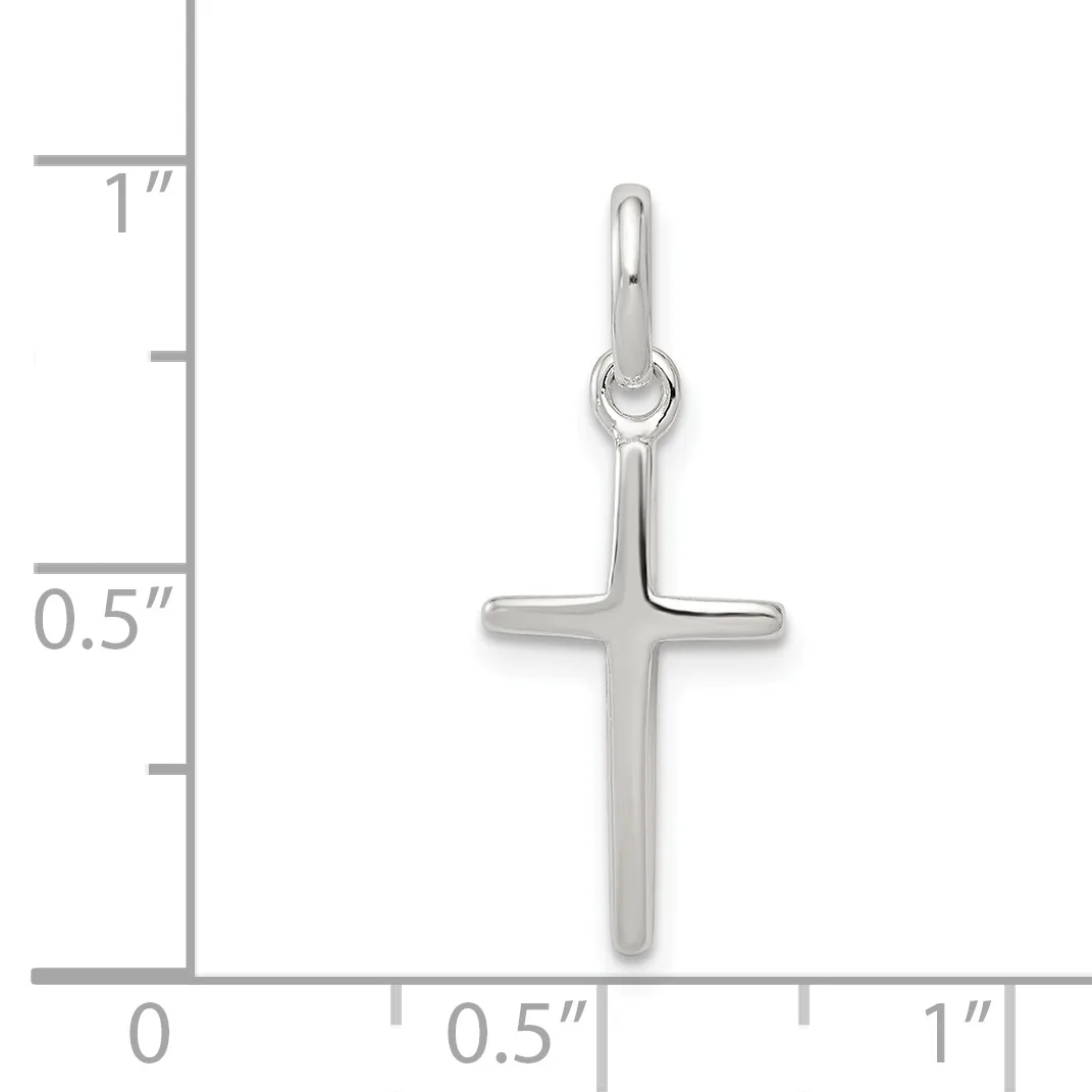 A silver cross pendant shown next to a ruler indicating its size is approximately 0.75 inches wide and 1 inch tall.