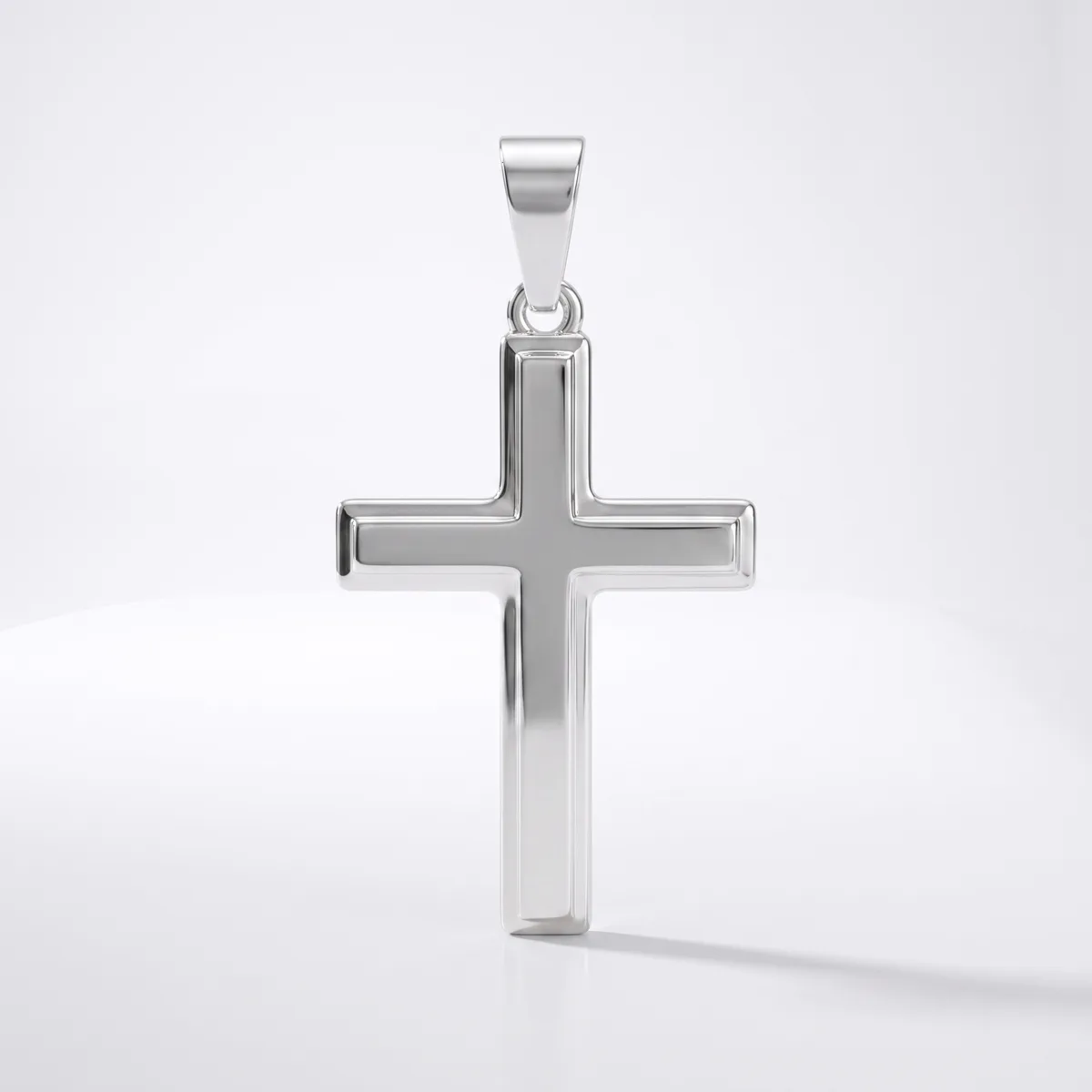 A polished silver cross pendant with a hollow rectangular design and rounded edges, displayed against a white background with a subtle shadow.