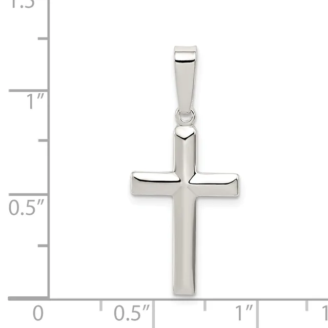 A polished silver cross pendant with a rectangular bail, shown against a measurement scale indicating approximately one inch in height.