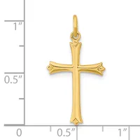 A gold cross pendant with flared ends and decorative points, shown against a measurement scale indicating approximately one inch in height.