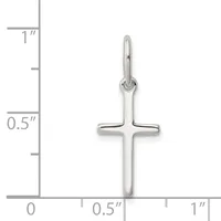 A polished silver cross pendant with a looped bail at the top, shown against a measurement scale indicating approximately one inch in height.