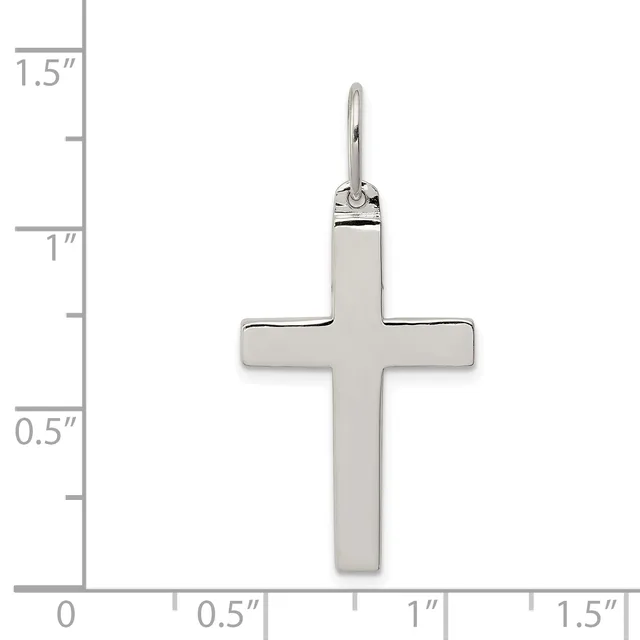 A polished silver cross pendant displayed against a measurement scale showing its dimensions of approximately 1.5 inches in height and 1 inch in width.