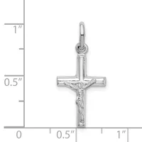 Silver crucifix pendant with corpus figure, shown against a ruler indicating approximately one inch in height.