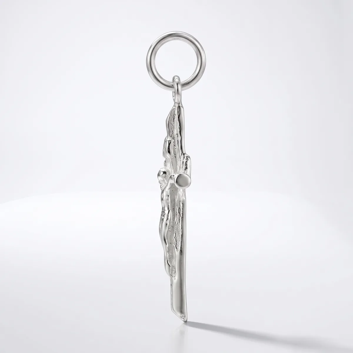 Silver keychain with an ornate tassel pendant featuring decorative metalwork and a small spherical stone detail, hanging from a split ring against a white background.