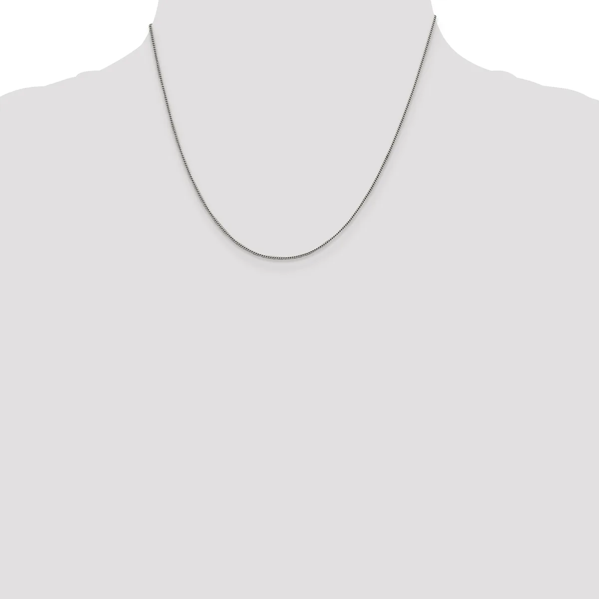 A thin silver chain necklace displayed on a mannequin torso against a white background.