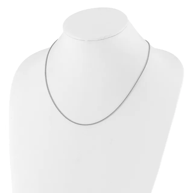 A thin silver-toned chain necklace displayed on a white mannequin bust.