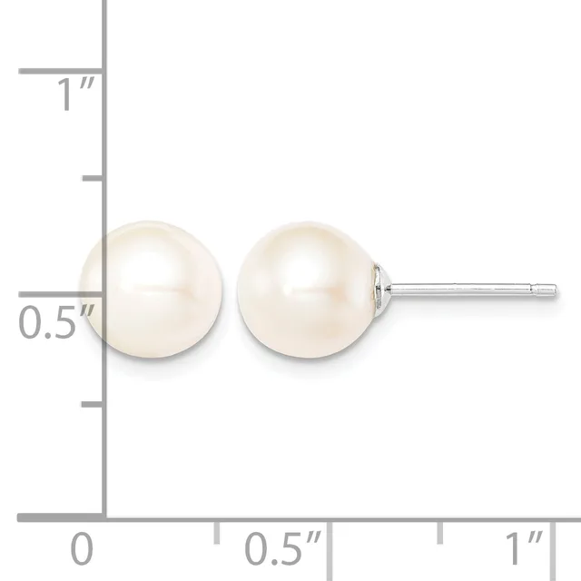 A pair of white pearl stud earrings displayed against a measurement scale showing approximately 0.5 inches in diameter.