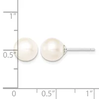 A pair of white pearl stud earrings displayed against a measurement scale showing approximately 0.5 inches in diameter.