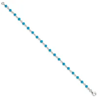 A silver bracelet with alternating round turquoise beads and decorative silver spacers, featuring a lobster clasp closure.