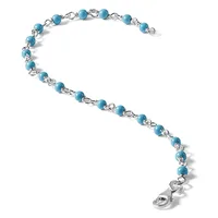 Silver bracelet with turquoise blue beads connected by decorative silver links, featuring a lobster claw clasp at the end.