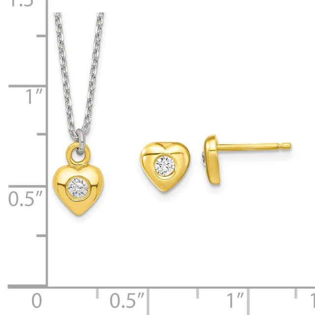 Gold heart-shaped pendant necklace and matching stud earrings, each featuring a center round white stone, displayed on a measurement scale.