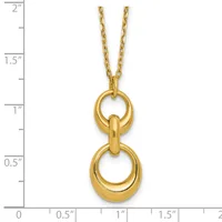 Gold-toned pendant necklace featuring two stacked polished rings connected by a curved bar, displayed on a ruler showing approximately two inches in length.