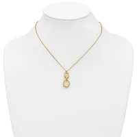 Gold-toned necklace with a delicate chain and a pendant featuring two stacked open circles, displayed on a white mannequin bust.