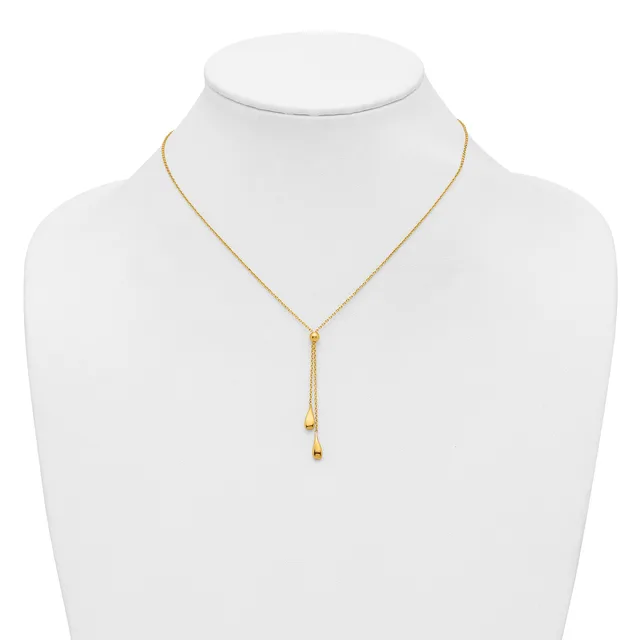 Gold-toned adjustable lariat necklace with small cube charms hanging from two delicate chains, displayed on a white mannequin bust.
