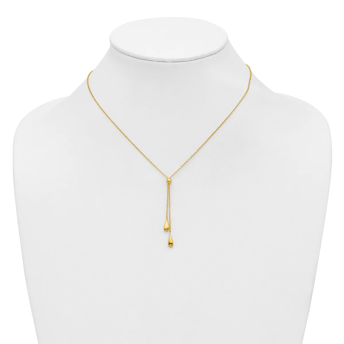 Gold-toned adjustable lariat necklace with small cube charms hanging from two delicate chains, displayed on a white mannequin bust.