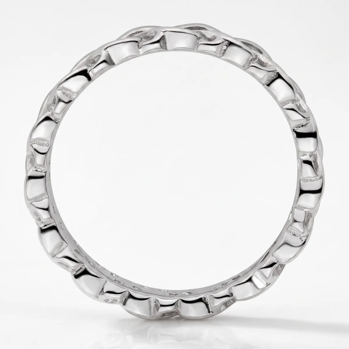 A polished silver ring band with a repeating scalloped or ridged texture around its entire circumference, photographed upright on a white background.