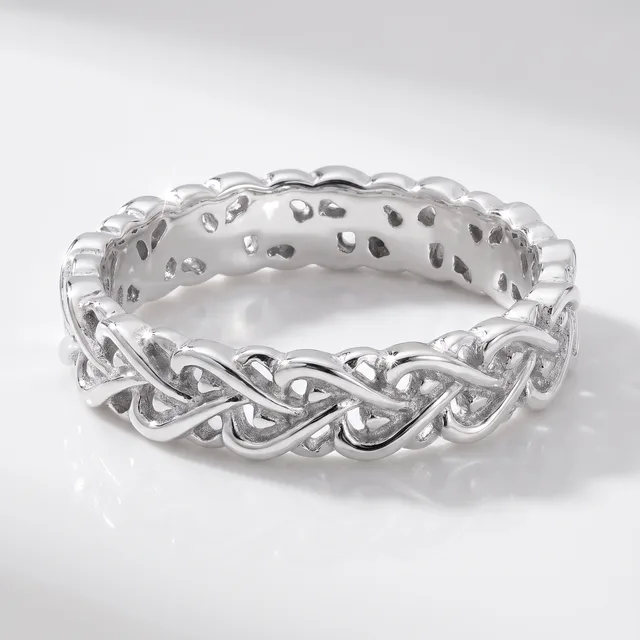 A silver braided twist band ring with an open weave design, photographed on a white reflective surface.
