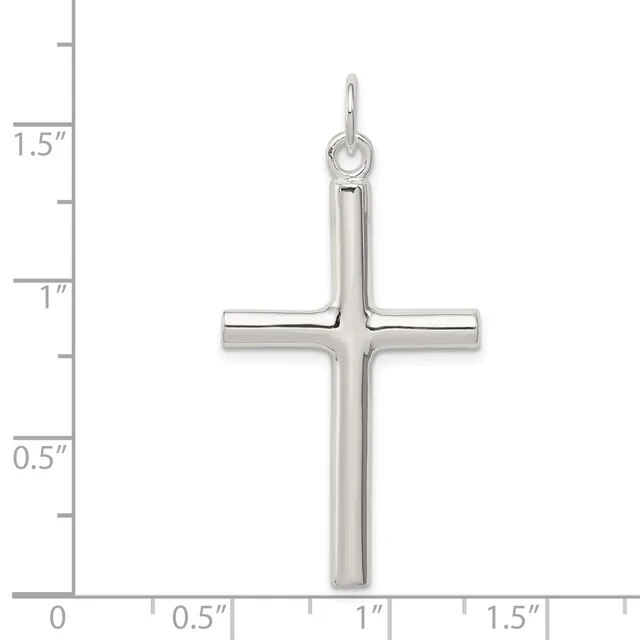 A polished silver cross pendant with a rounded top loop, shown next to a ruler indicating its height is approximately 1.5 inches.