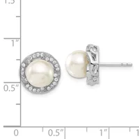 Pair of white pearl stud earrings with diamond halos set in white metal, displayed next to a measurement ruler.