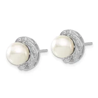 A pair of stud earrings featuring white pearls surrounded by pavé-set diamonds in white metal, shown from the front.