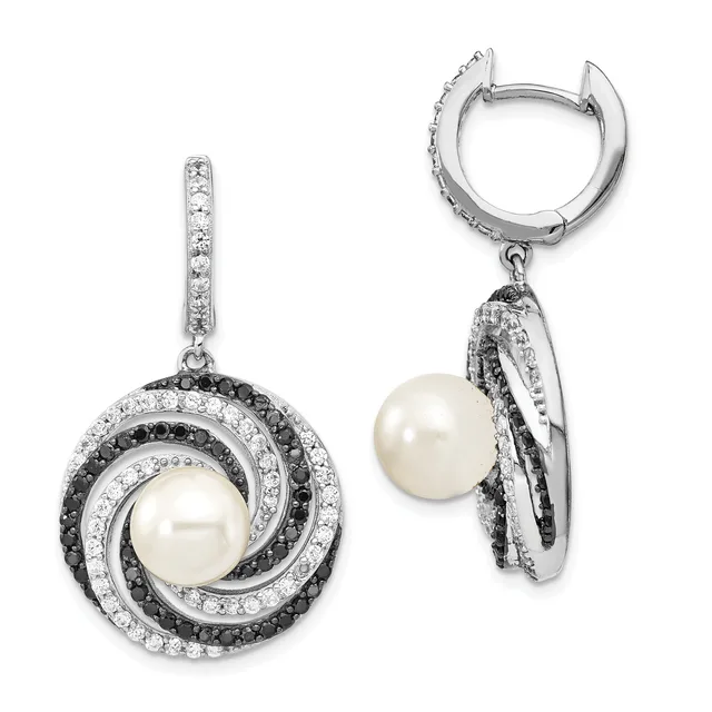 A pair of silver drop earrings featuring white pearls surrounded by concentric circles of black and white diamonds, shown from front and side views.