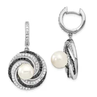 A pair of silver drop earrings featuring white pearls surrounded by concentric circles of black and white diamonds, shown from front and side views.