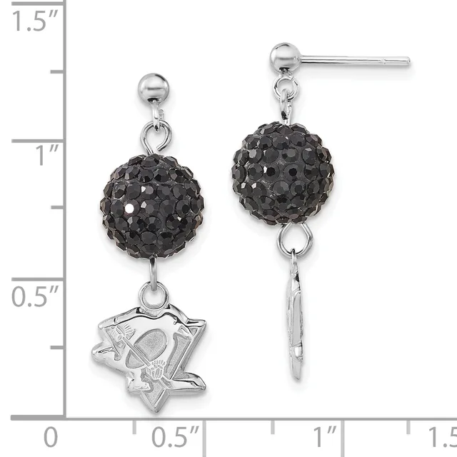 A pair of silver dangle earrings with black crystal ball tops and mismatched bottoms: one featuring a star-shaped charm and the other a plain silver bar, shown against a measurement scale.