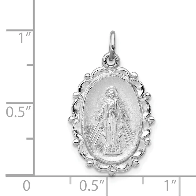 Silver oval religious medal pendant with scalloped border and loop, shown next to a ruler indicating approximately one inch in height.