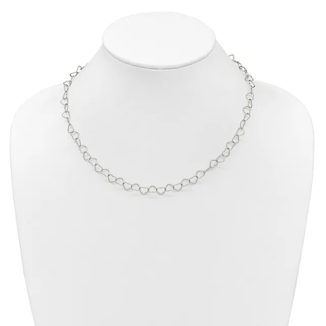 A delicate silver-toned chain necklace with small circular link details displayed on a white mannequin bust.