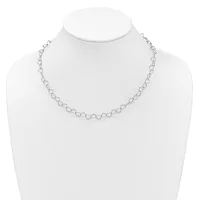 A delicate silver-toned chain necklace with small circular link details displayed on a white mannequin bust.