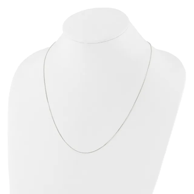 A thin silver chain necklace displayed on a white mannequin bust.