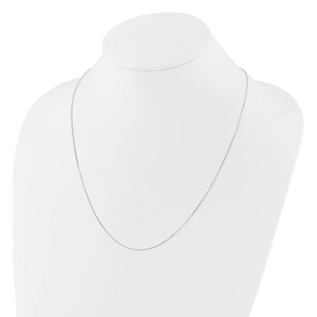 A thin silver chain necklace displayed on a white mannequin bust.