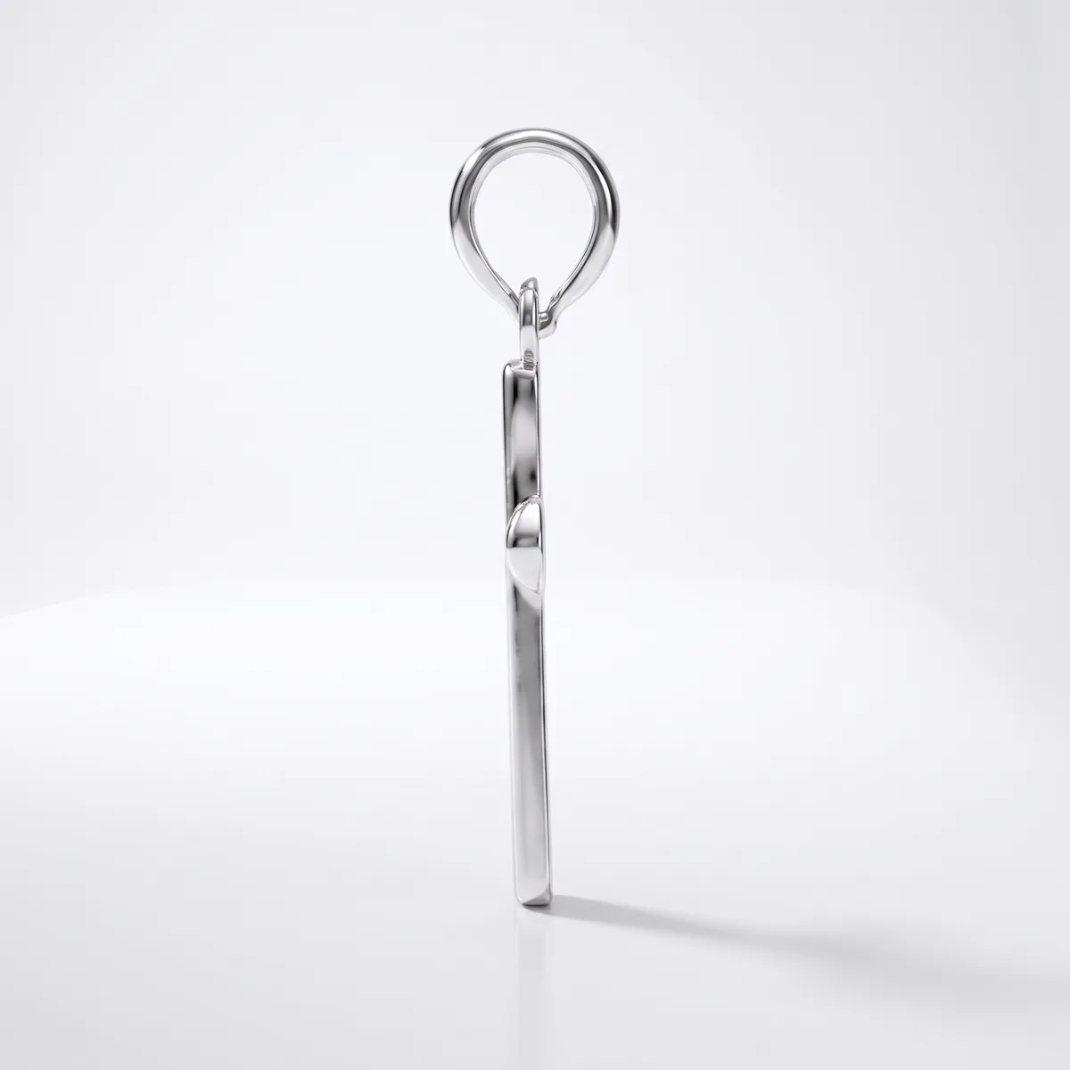 A polished metal keyring with a circular loop at the top and a rectangular body, shown vertically against a white background with a shadow cast to the right.