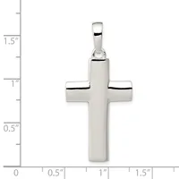 A polished silver cross pendant with rounded edges and a small bail loop at the top, shown with a ruler indicating it measures approximately 1.5 inches in height.