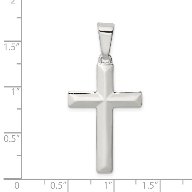 A polished silver cross pendant with rounded edges and a bail at the top, shown against a measurement scale indicating approximately 1.5 inches in height.