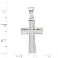 A polished silver cross pendant shown against a measurement scale, approximately 1.25 inches tall and 0.75 inches wide, with a rounded bail at the top.