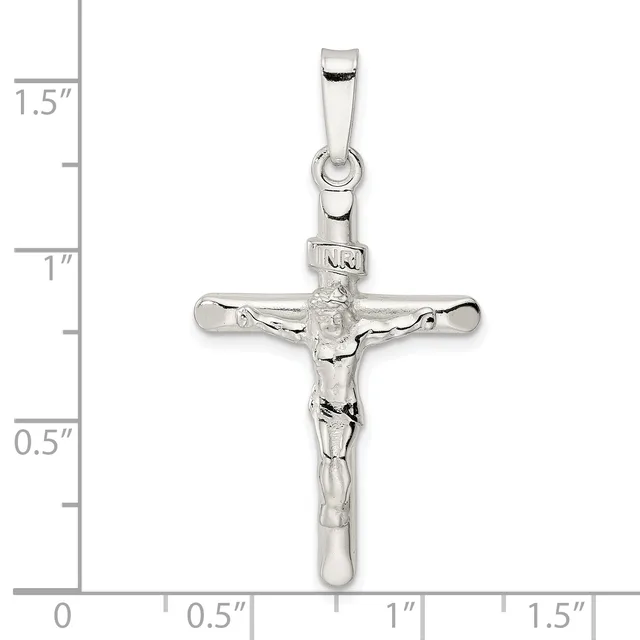 Sterling silver crucifix pendant with detailed corpus figure, shown against a ruler measuring approximately 1.5 inches in height.