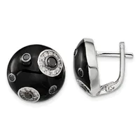 A pair of black onyx dome earrings with silver settings, decorated with small diamonds arranged in circular patterns around the surface, shown from front and side views.