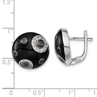 A pair of black onyx and silver earrings with diamond accents, shown from front and side views next to a measurement ruler indicating approximately one inch in diameter.